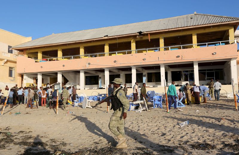 © Reuters. A soldier patrols on Lido beach following an attack at beachside restaurant Beach View Cafe, in Somalia's capital Mogadishu