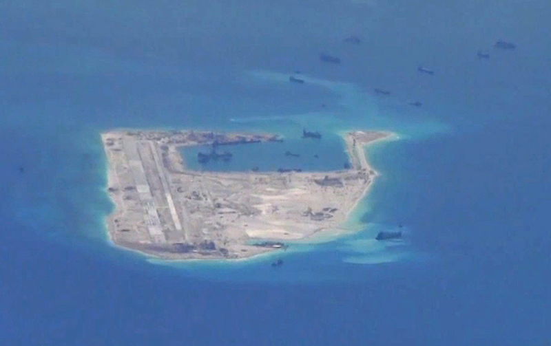 © Reuters. File photo from a United States Navy video purportedly shows Chinese dredging vessels in the waters around Fiery Cross Reef in the disputed Spratly Islands