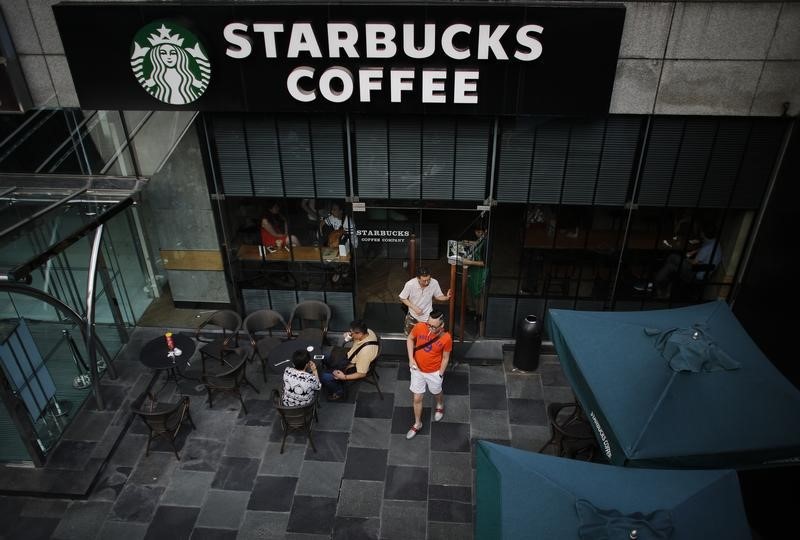 © Reuters. Customers walk out of a Starbucks coffee store in Shanghai