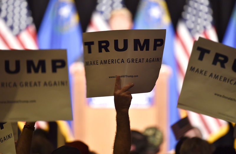 © Reuters. Supporters displays placards as U.S. Republican presidential candidate and businessman Donald Trump speaks at a campaign rally at the South Point Resort and Casino in Las Vegas