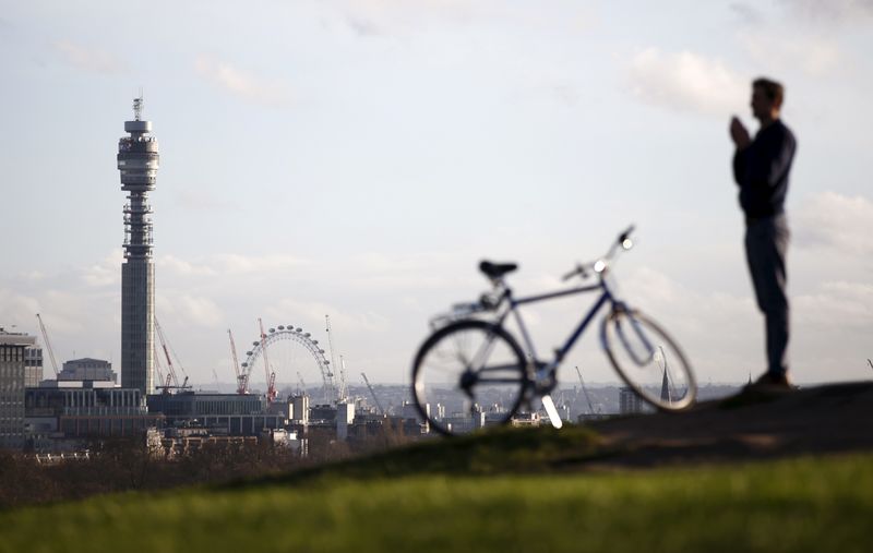 © Reuters. File photograph shows a man looking towards the Telecom Tower, from Primrose Hill in London