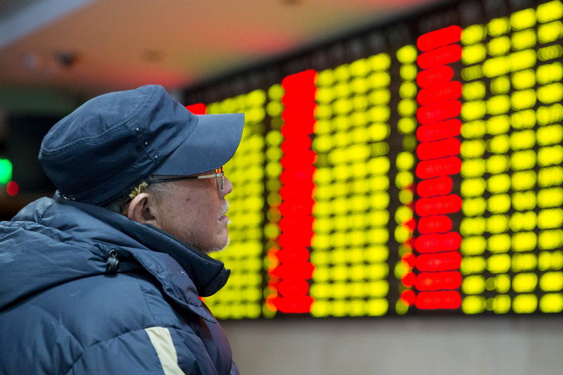 © Reuters. An investor looks at an electronic screen showing stock information at a brokerage house in Nanjing