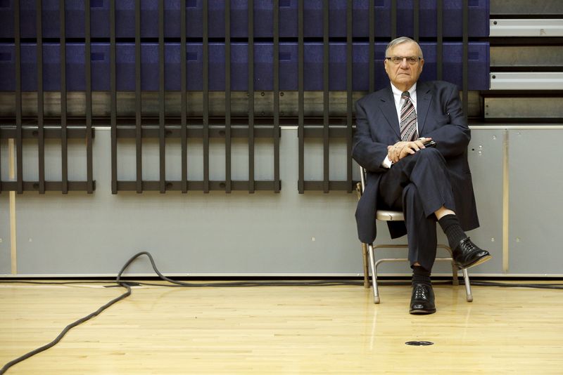 © Reuters. Maricopa County Sheriff Joe Arpaio listens to U.S. Republican presidential candidate Donald Trump speak at a campaign rally in Marshalltown