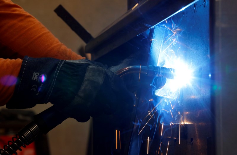 © Reuters. A worker welds in a factory in Gravellona Lomellina