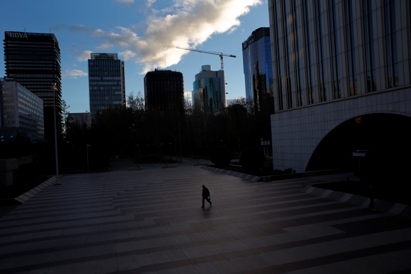 © Reuters. A man walks at a business district in Madrid