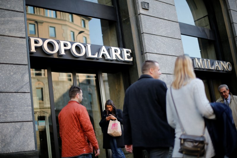 © Reuters. People walk past the entrance of Banca Popolare di Milano (BPM) headquarters in downtown Milan