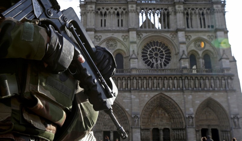 © Reuters. File picture shows an armed French soldier who patrols in front of Notre Dame Cathedral in Paris