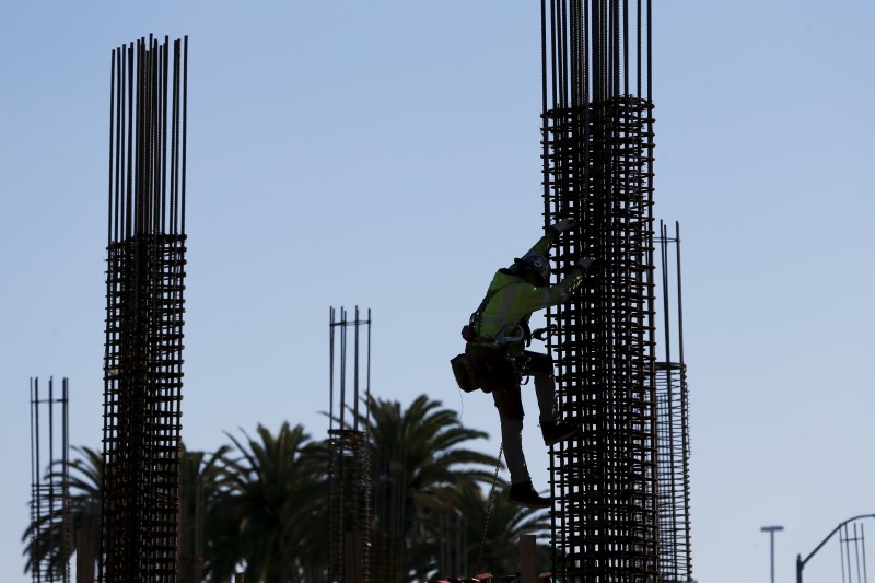 © Reuters. A worker climbs a fixture at a construction site in East Palo Alto, California
