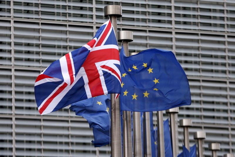 © Reuters. File photo of a Union Jack flag fluttering next to European Union flags ahead of a visit from Britain's Prime Minister Cameron at the EU Commission headquarters in Brussels