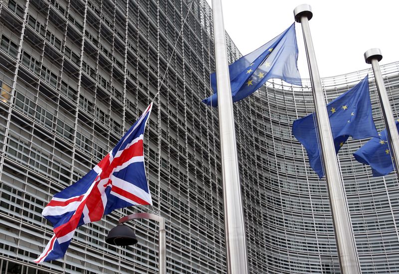 © Reuters. A Union Jack flag is raised next to European Union flags ahead of a visit from Britain's Prime Minister David Cameron at the EU Commission headquarters in Brussels