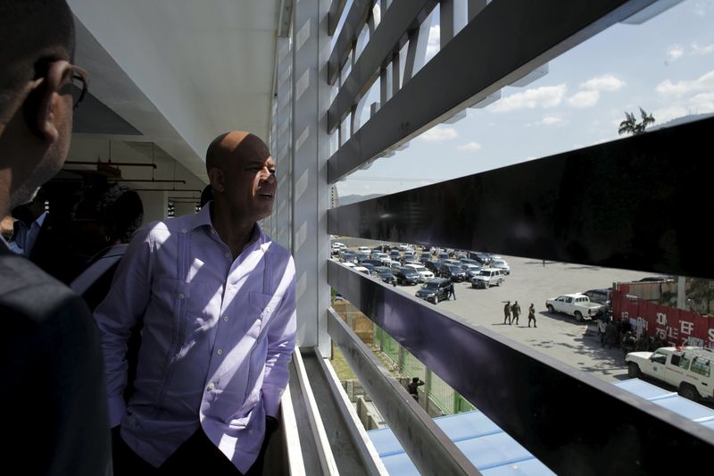 © Reuters. Outgoing Haiti's President Martelly looks outside of the Ministry of Interior during the inauguration of the new building in Port-au-Prince