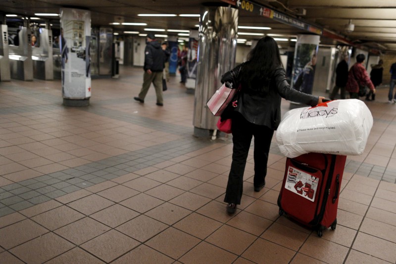 © Reuters. A shopper walks through the Herald Square Subway station after early morning Black Friday Shopping in New York