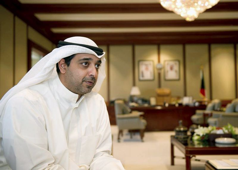 © Reuters. File photo of Kuwait's Minister for Cabinet and Municipal Affairs Sheikh Mohammad al-Mubarak Al-Sabah speaking in his office in Kuwait City