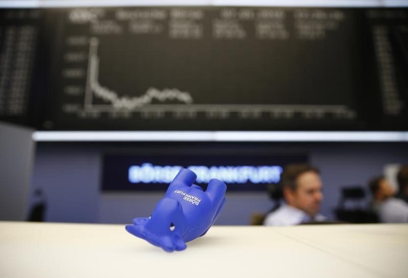 © Reuters. A styrofoam bull figure lies on its side in front of DAX board at Frankfurt's stock exchange