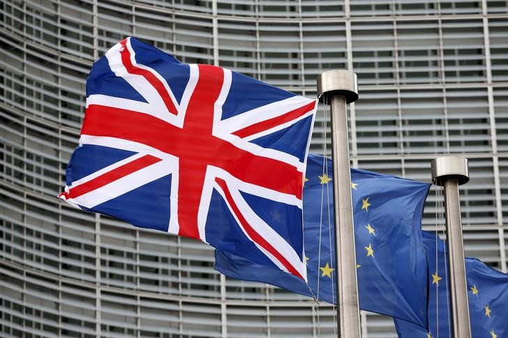 © Reuters. A Union Jack flag flutters next to European Union flags ahead of a visit from Britain's Prime Minister David Cameron at the EU Commission headquarters in Brussels