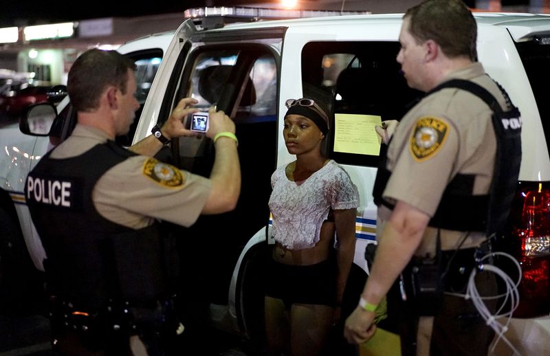 © Reuters. File photo of police taking a mugshot of a protester who was detained in Ferguson, Missouri