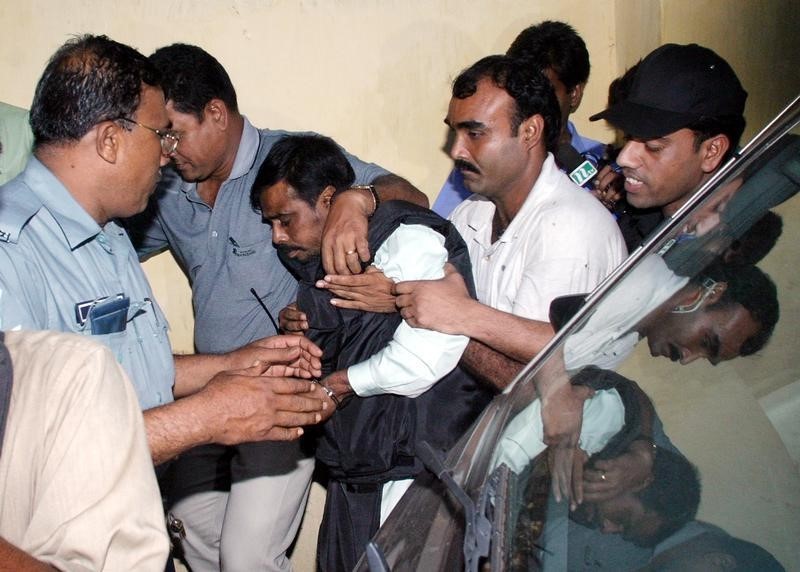 © Reuters. Police escort Mufti Abdul Hannan to a Dhaka court
