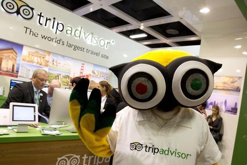 © Reuters. A mascot of tripadvisor is seen at its stand at the International Tourism Trade Fair (ITB) in Berlin