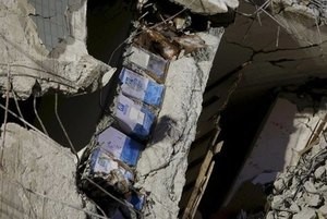 © Reuters. File picture of cooking oil cans seen in the debris of a 17-storey apartment building which collapsed after an earthquake hit Tainan, southern Taiwan