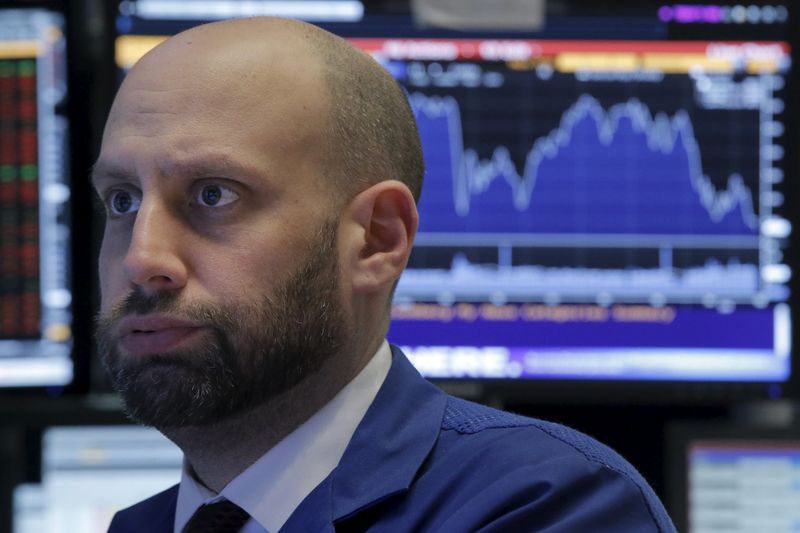 © Reuters. A specialist trader works at his post on the floor of the NYSE 
