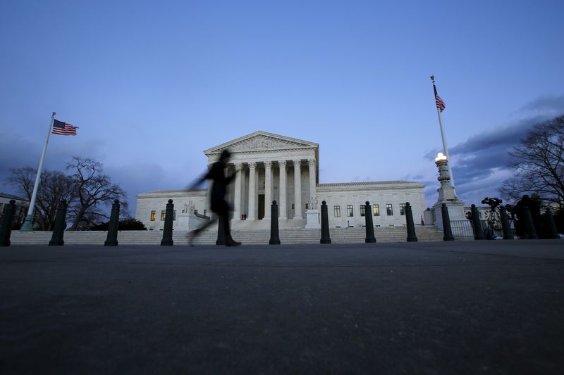 © Reuters. A woman walks past the Supreme Court building at Capitol Hill in Washington D.C.