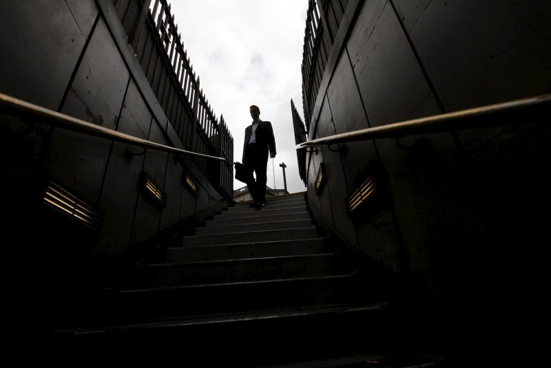© Reuters. File photo of a man walking down steps into Bank tube station in the City of London