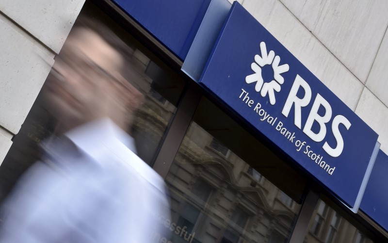 © Reuters. File photo of a man walking past a branch of The Royal Bank of Scotland in central London