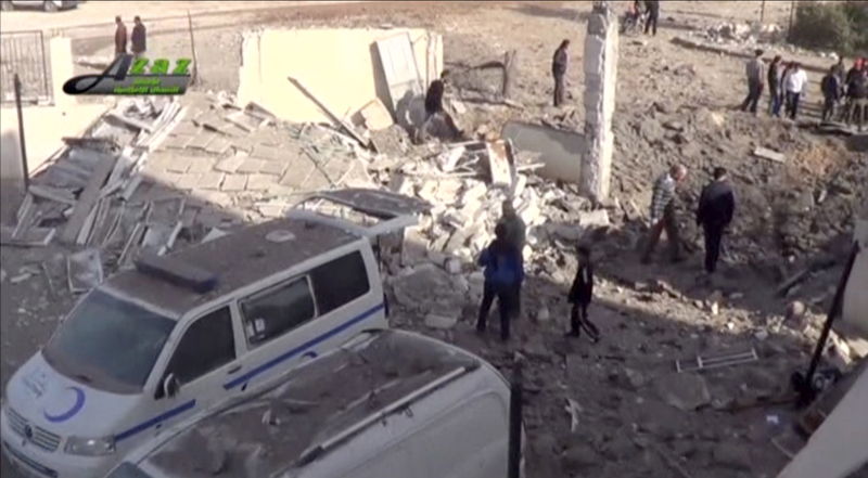 © Reuters. Still image taken from video shows people gathering near what is said to be a hospital damaged by missile attacks in Azaz