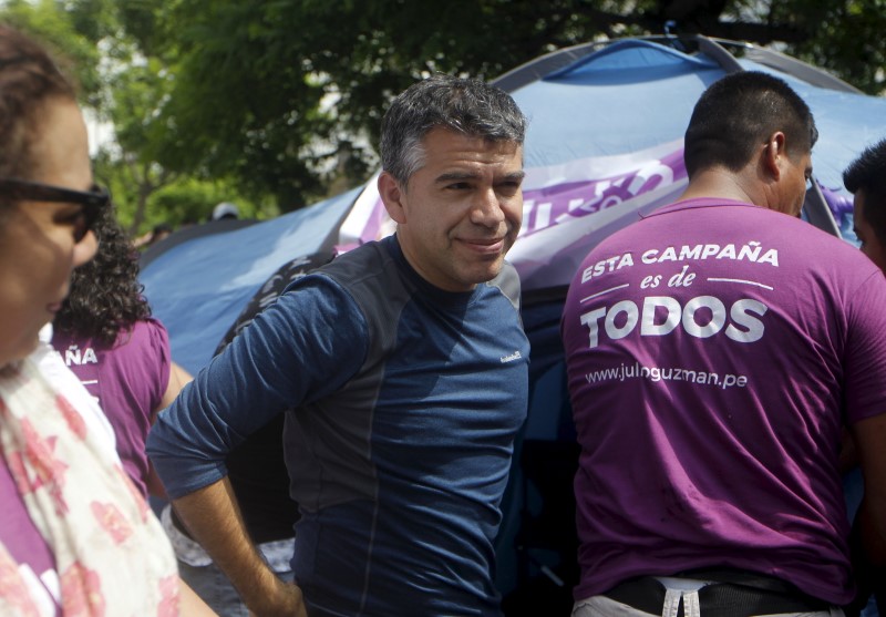 © Reuters. Peru's "Todos por el Peru" (All for Peru) party presidential candidate Julio Guzman stands outside his tent after spending a night in vigil outside Peru's electoral board in Lima