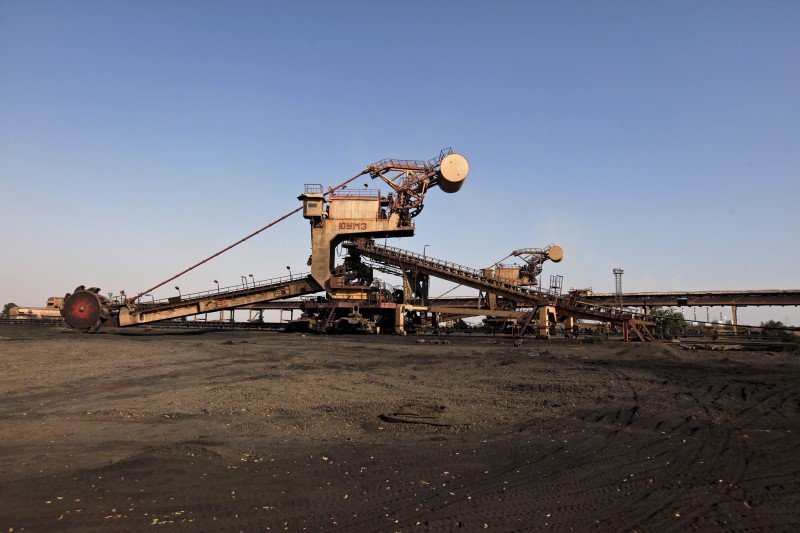 © Reuters. A universal machine made in the USSR stands in open ground near the conveyer belt at coal handling plant at the Pakistan Steel Mills on the outskirts of Karachi