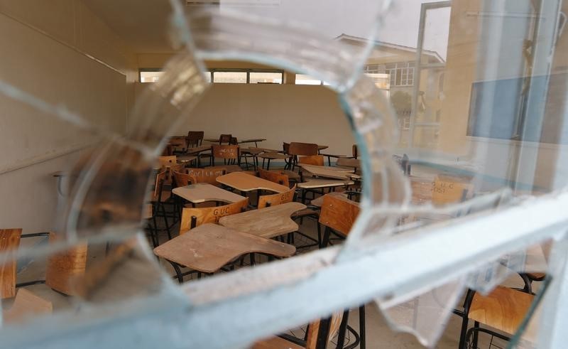 © Reuters. Chairs are seen through a broken window at the Garissa University College in Garissa