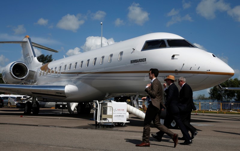 © Reuters. Visitors walk past a Bombardier Global 6000 aircraft displayed at the Singapore Airshow at Changi Exhibition Center 