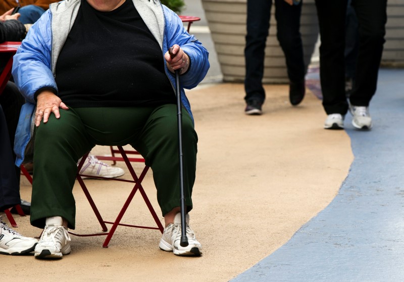 © Reuters. An overweight woman sits on a chair in Times Square in New York