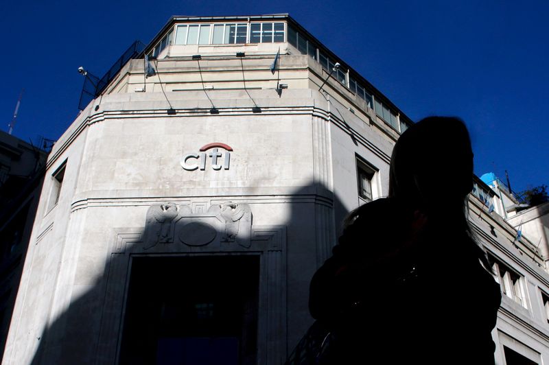 © Reuters. File photo of a woman walking past Citibank headquarters in Buenos Aires' financial district