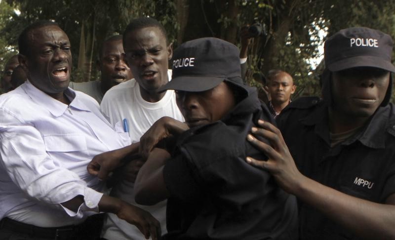 © Reuters. Ugandan policemen arrest opposition leader Besigye ahead of a rally to demonstrate against corruption and economic hardships in Uganda's capital Kampala