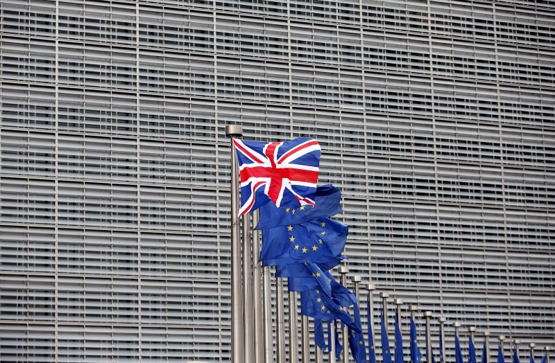 © Reuters. File photo of a Union Jack flag fluttering next to European Union flags ahead of a visit from Britain's Prime Minister David Cameron at the EU Commission headquarters in Brussels