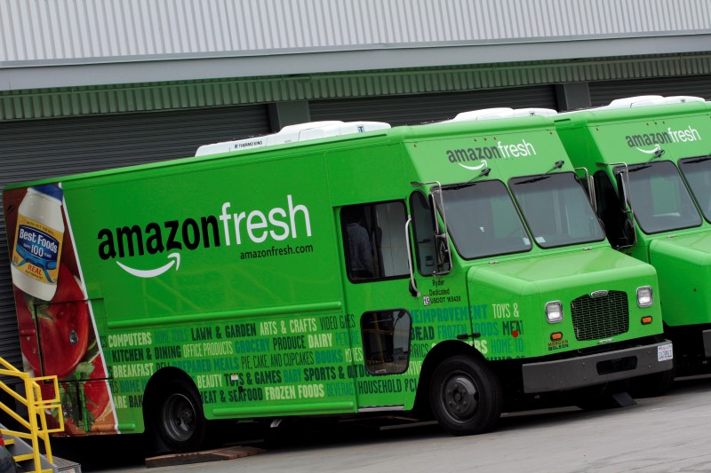 © Reuters. Amazon Fresh delivery vans are parked at an Amazon Fresh warehouse in Inglewood