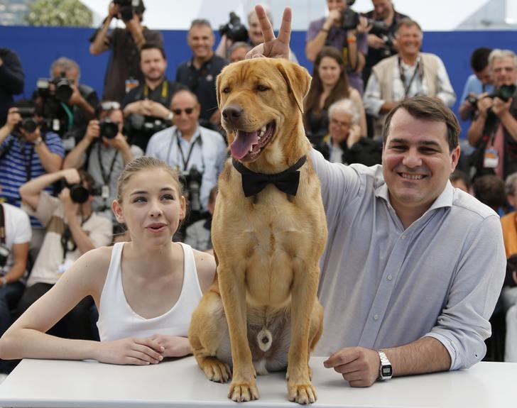 © Reuters. Diretor Mundruczo e atriz Psotta posam com cachorro no Festival de Cannes 