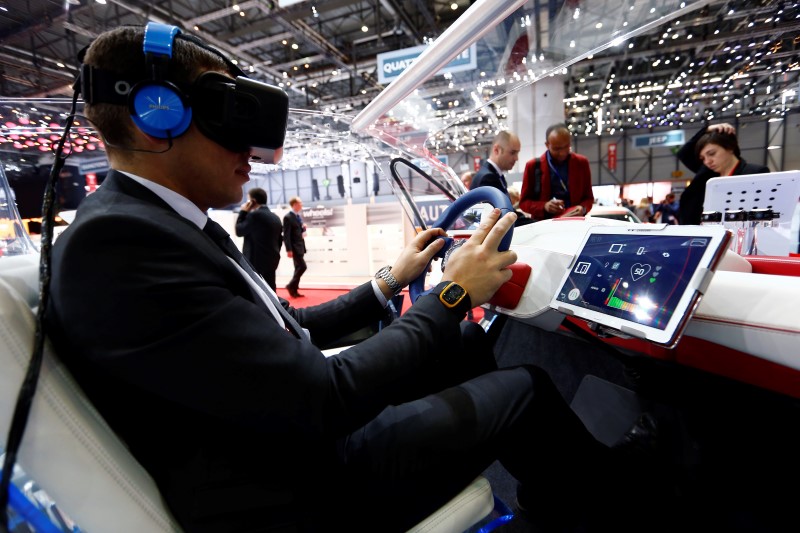 © Reuters. An employee sits inside a virtual reality connected car cockpit built by Segula Technologies during the first press day ahead of the 85th International Motor Show in Geneva