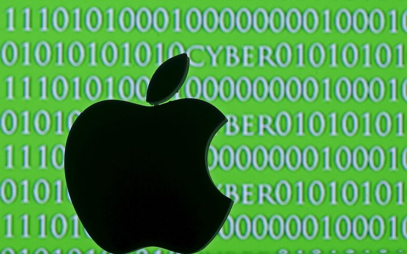 © Reuters. Picture illustration of a 3D printed Apple logo seen in front of a displayed cyber code