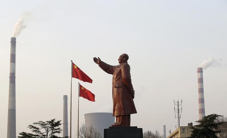 © Reuters. Статуя Мао Цзэдунана фоне труб завода Wuhan Iron And Steel Corp в Ухане