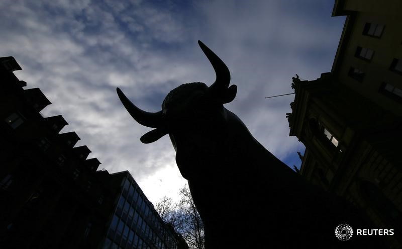 © Reuters. A bull, symbol of successful burse trading is silhouetted outside the stock exchange in Frankfurt