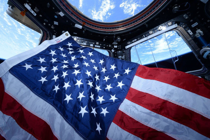 © Reuters. The crew of Expedition 44 prepares to observe U.S. Flag Day in the Cupola