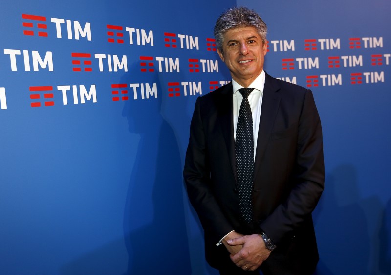 © Reuters. Telecom Italia CEO Patuano poses in front of the new logo of its TIM brand in Rome