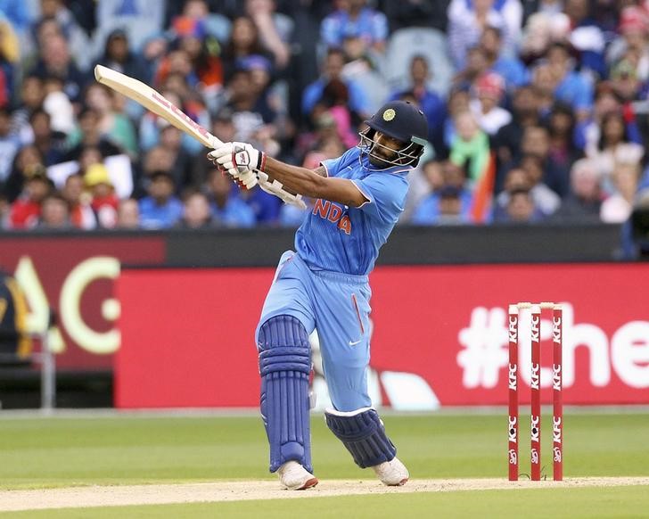 © Reuters. India's Shikhar Dhawan hits a six while batting against Australia during their T20 cricket match at the Melbourne Cricket Ground