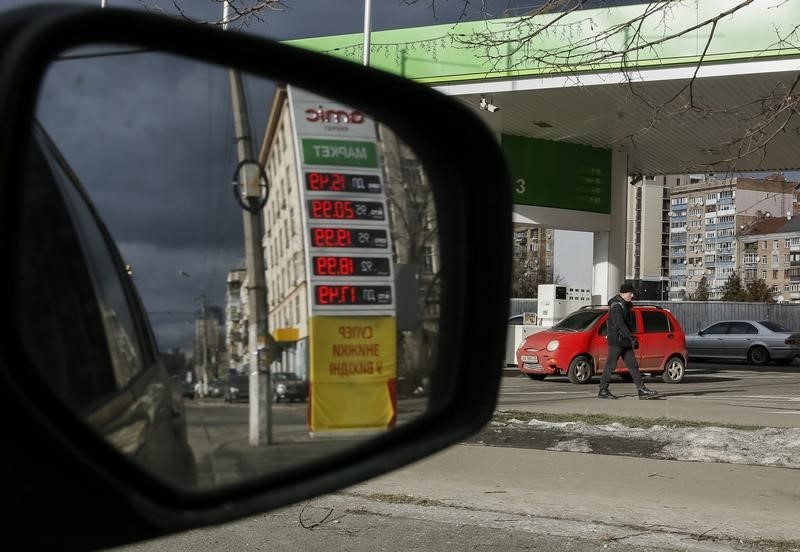 © Reuters. A man walks past "Amic" fuel stations in Kiev