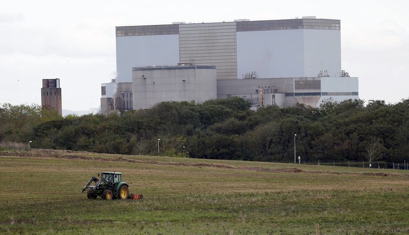 © Reuters. File photograph of a tractor mowing a field on the site where EDF Energy's Hinkley Point C nuclear power station will be constructed in Bridgwater