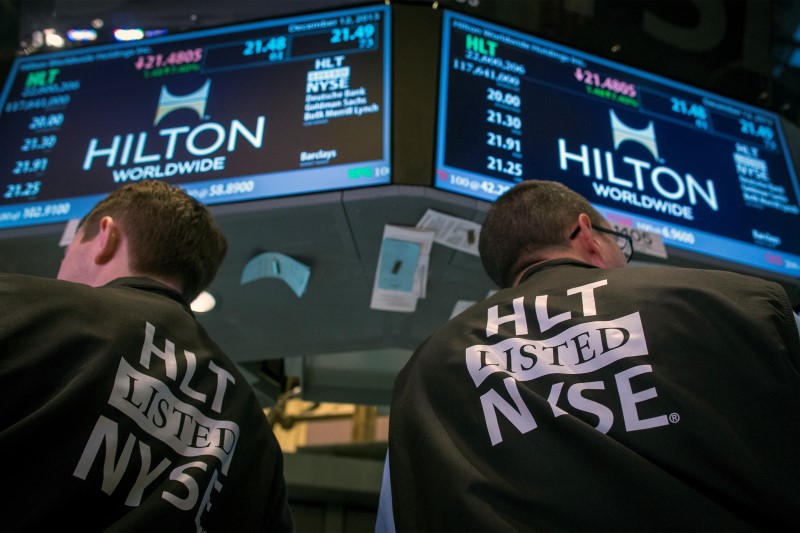 © Reuters. Traders wear special vests for the Hilton IPO on the floor of the New York Stock Exchange