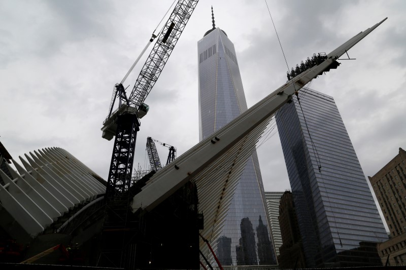 © Reuters. The One World Trade Center and Seven World Trade Center buildings are seen from the 9/11 Memorial site in New York