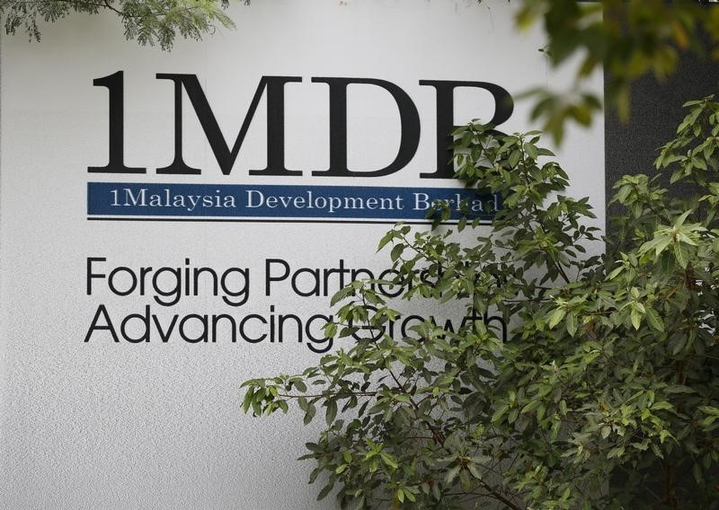 © Reuters. Foliage partly covers a 1 Malaysia Development Berhad (1MDB) billboard at the funds flagship Tun Razak Exchange development in Kuala Lumpur, Malaysia